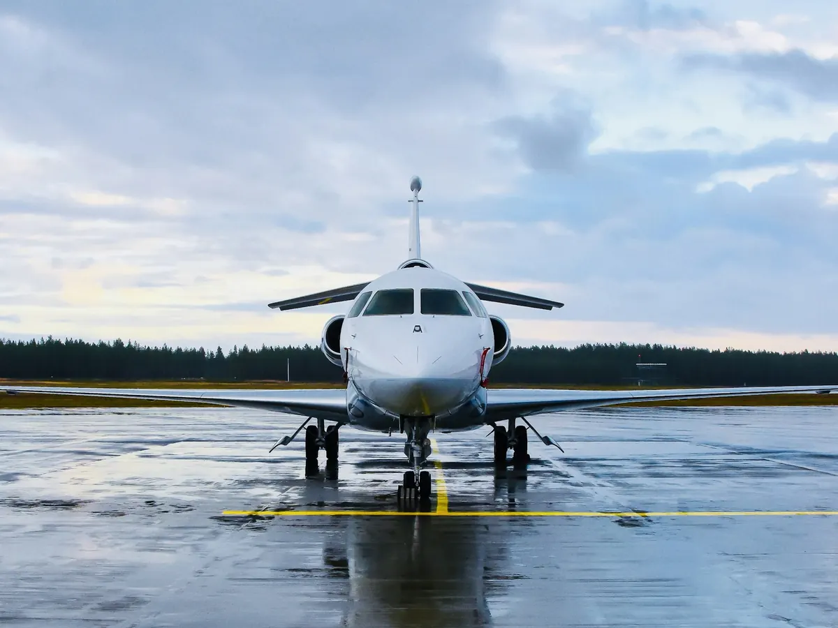 Business jet on a wet ramp under a dramatic sky